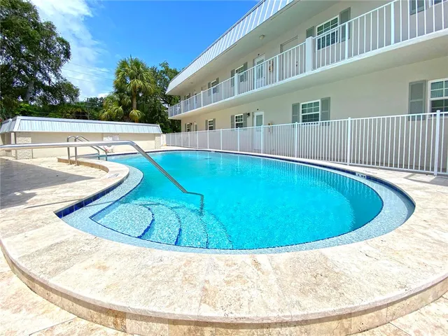 a view of swimming pool with outdoor seating