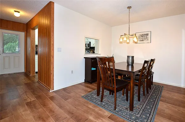 a view of a dining room with furniture window and wooden floor