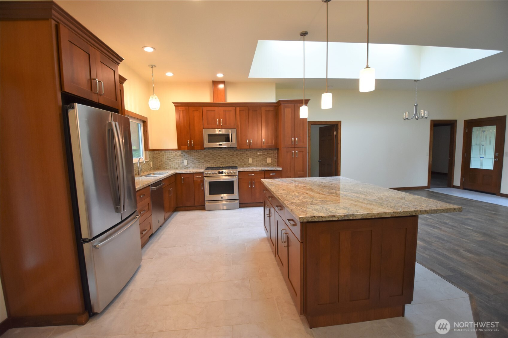 30331 Heimer Road Arlington, WA 98223 - Photo 19 of 37 a kitchen with stainless steel appliances granite countertop a refrigerator a sink a stove and a wooden floors