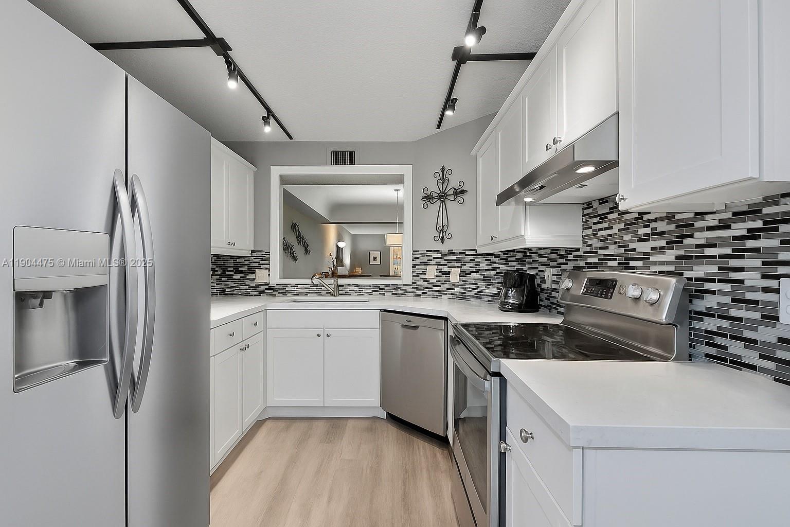 a kitchen with a sink stove and cabinets
