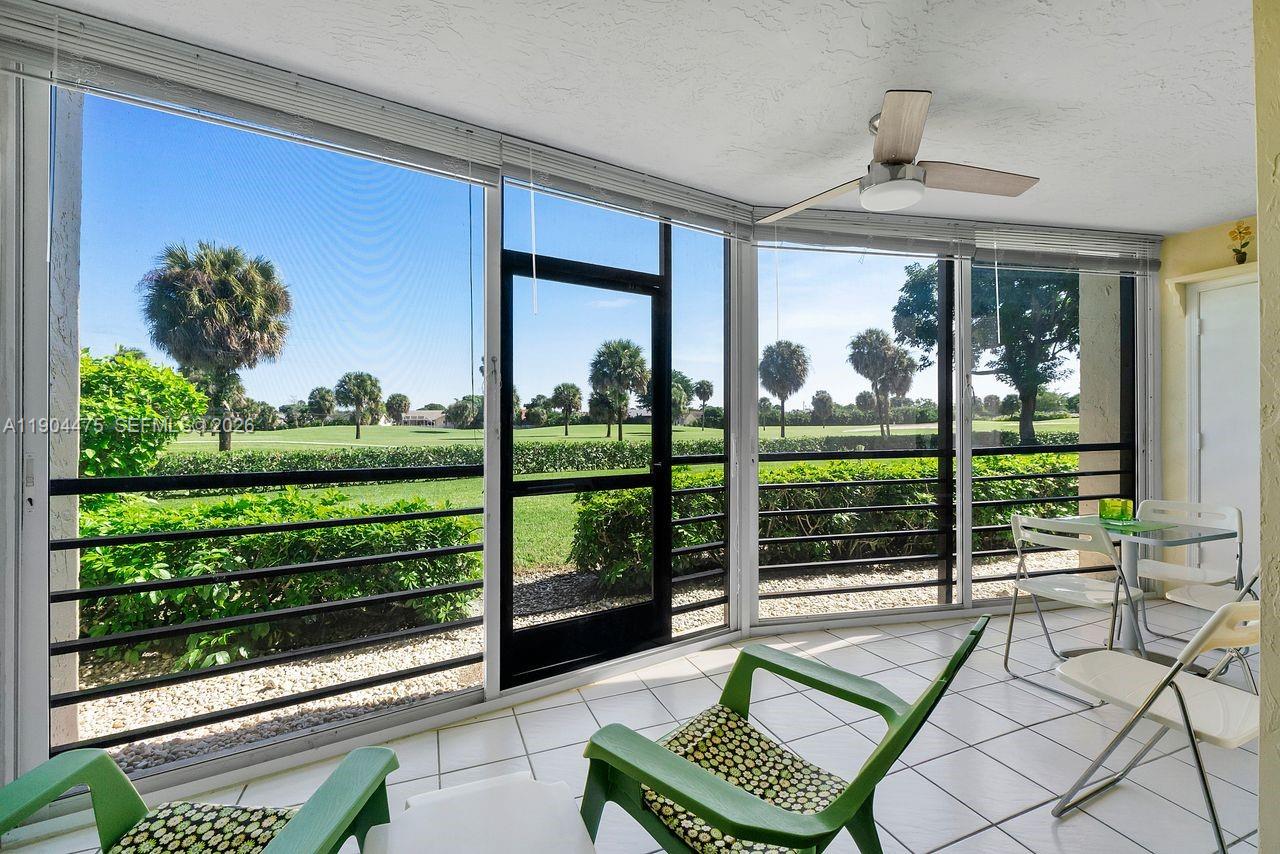 23249 Barwood Lane North, Unit 102 Boca Raton, FL 33428 - Photo 17 of 45 a view of a porch with furniture and garden