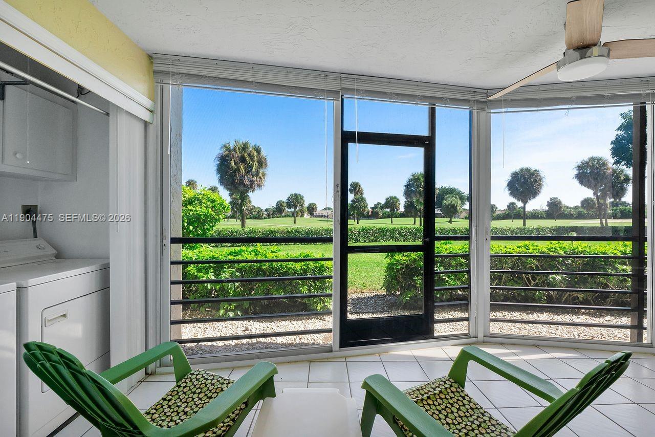 23249 Barwood Lane North, Unit 102 Boca Raton, FL 33428 - Photo 19 of 45 a living room filled with furniture and a floor to ceiling window