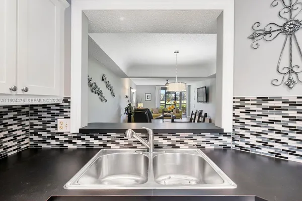 a kitchen with a sink and a stove top oven