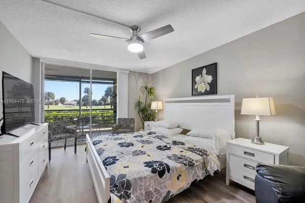 a bedroom with a bed and a large window