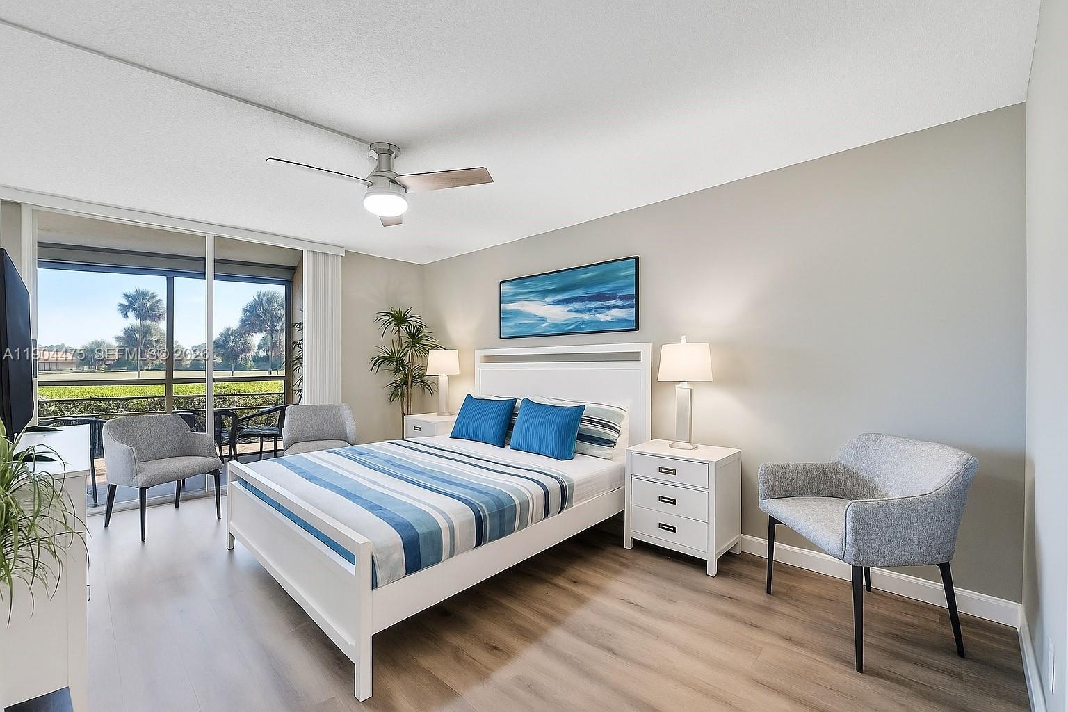 23249 Barwood Lane North, Unit 102 Boca Raton, FL 33428 - Photo 3 of 45 a bedroom with a bed and a table