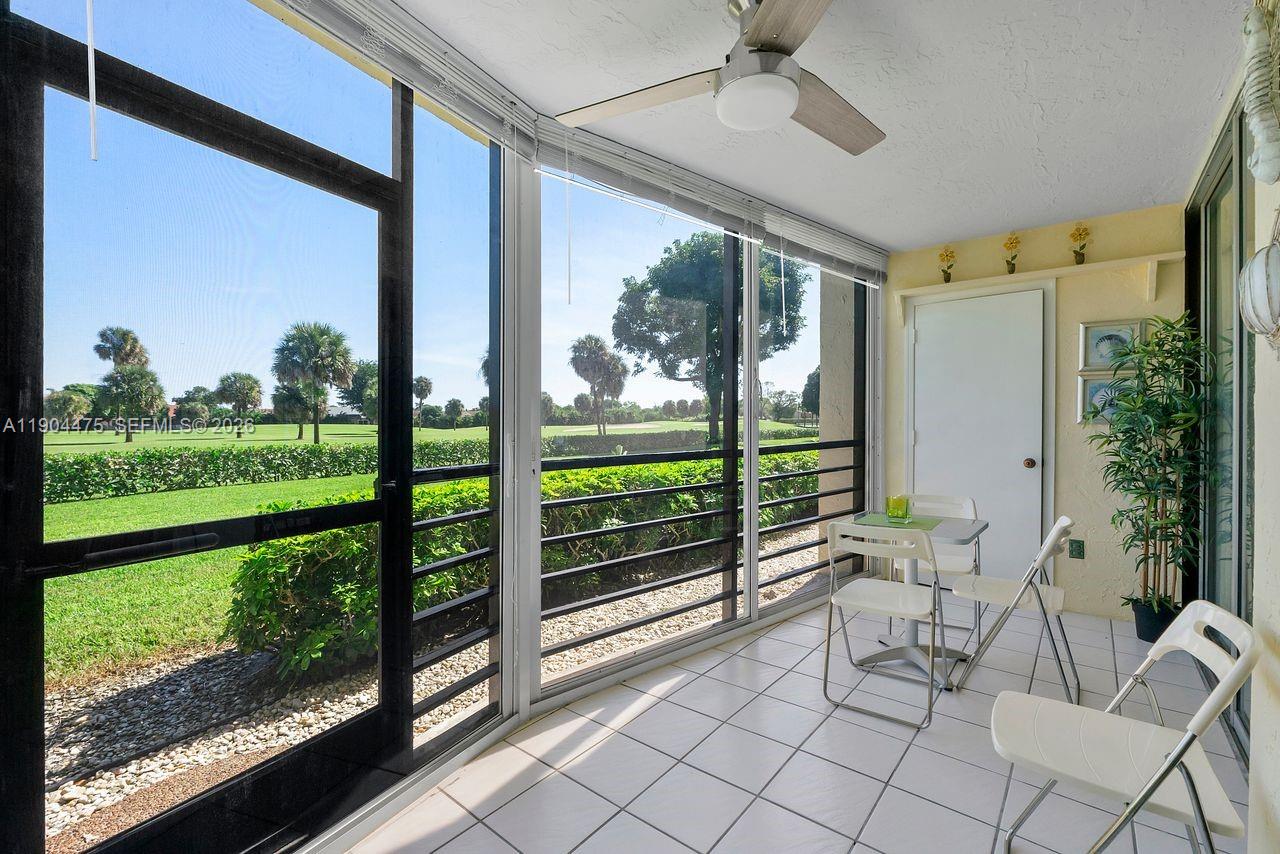 23249 Barwood Lane North, Unit 102 Boca Raton, FL 33428 - Photo 40 of 45 a view of a porch with furniture and garden