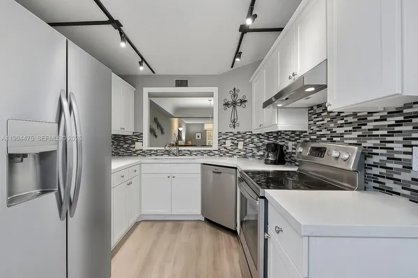 a kitchen with a sink stove and cabinets