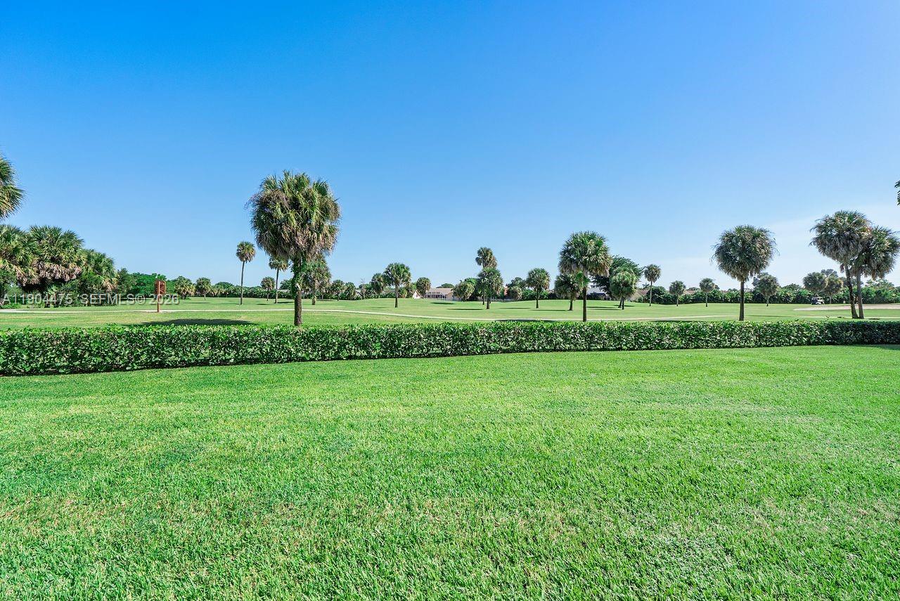 23249 Barwood Lane North, Unit 102 Boca Raton, FL 33428 - Photo 42 of 45 a view of a grassy field with trees