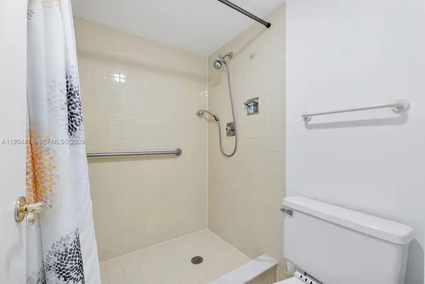 a bathroom with a shower a toilet and a shower