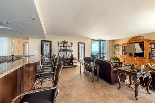 a living room with furniture and a dining table with projector the view