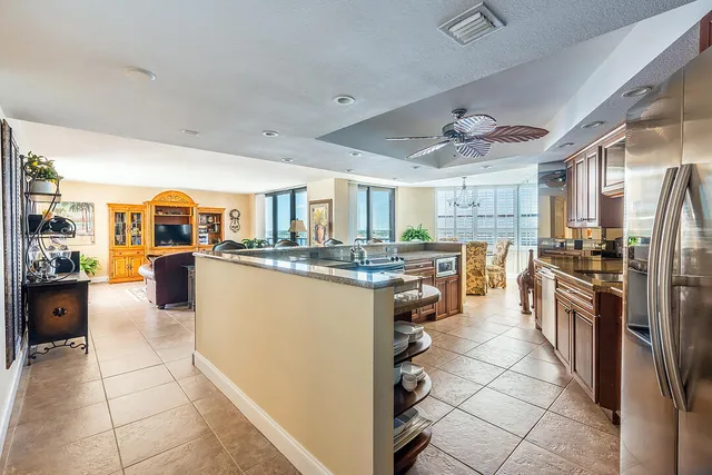 a kitchen with stainless steel appliances granite countertop a refrigerator and a sink