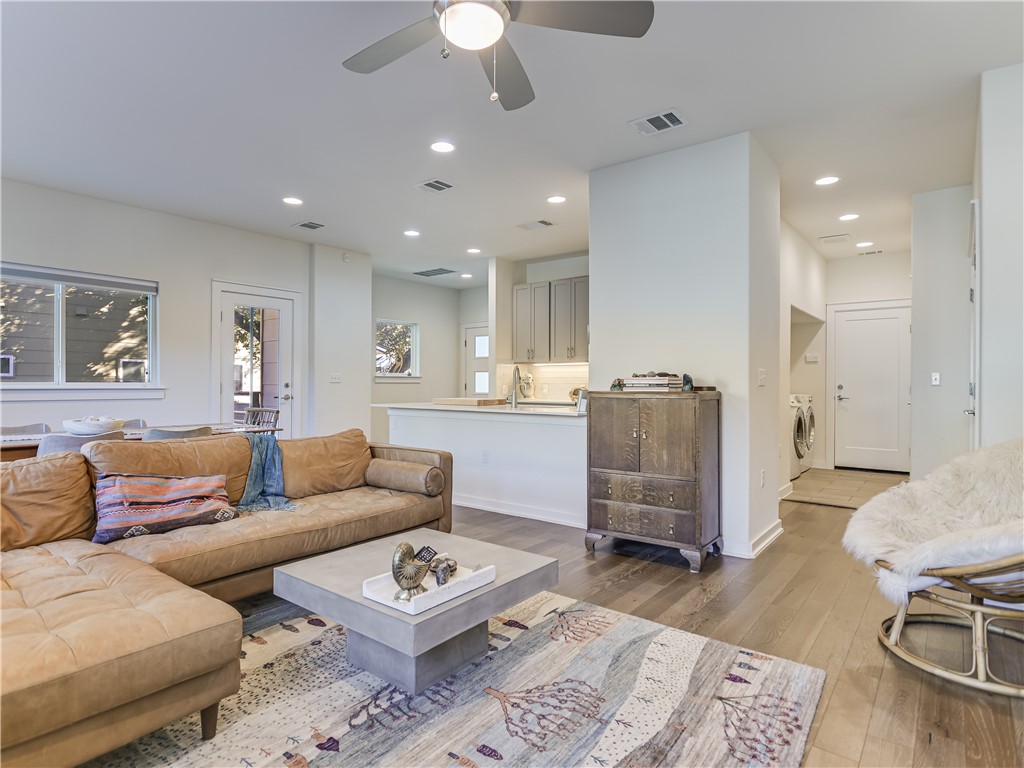 a living room with furniture and a wooden floor