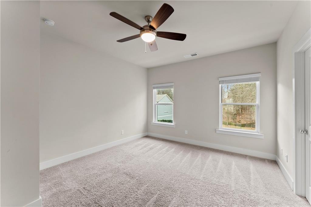 2178 Wiggins Walk Atlanta, GA 30316 - Photo 13 of 31 an empty room with ceiling fan and windows