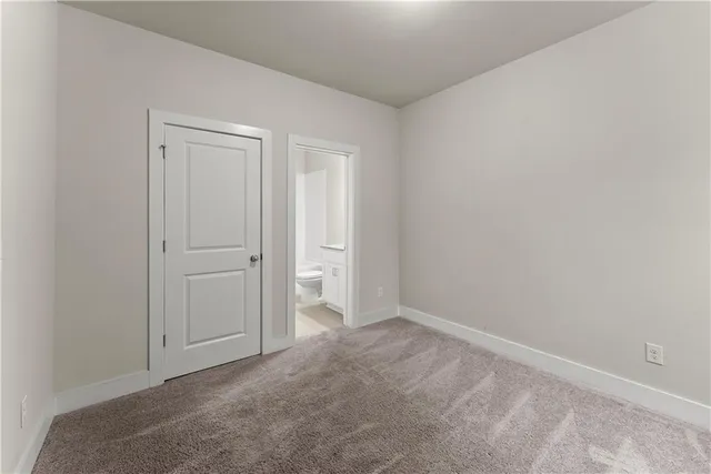 a view of an empty room and closet area