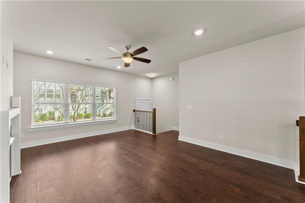 2178 Wiggins Walk Atlanta, GA 30316 - Photo 8 of 31 a view of an empty room with a window and wooden floor