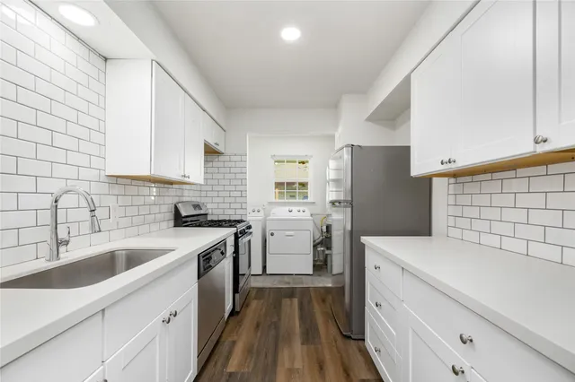 a kitchen with a sink cabinets and stainless steel appliances
