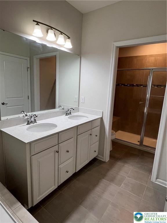 2356 Raya Way Easton, PA 18045 - Photo 15 of 28 A classic double vanity with stone counters complements the spacious tile flooring.