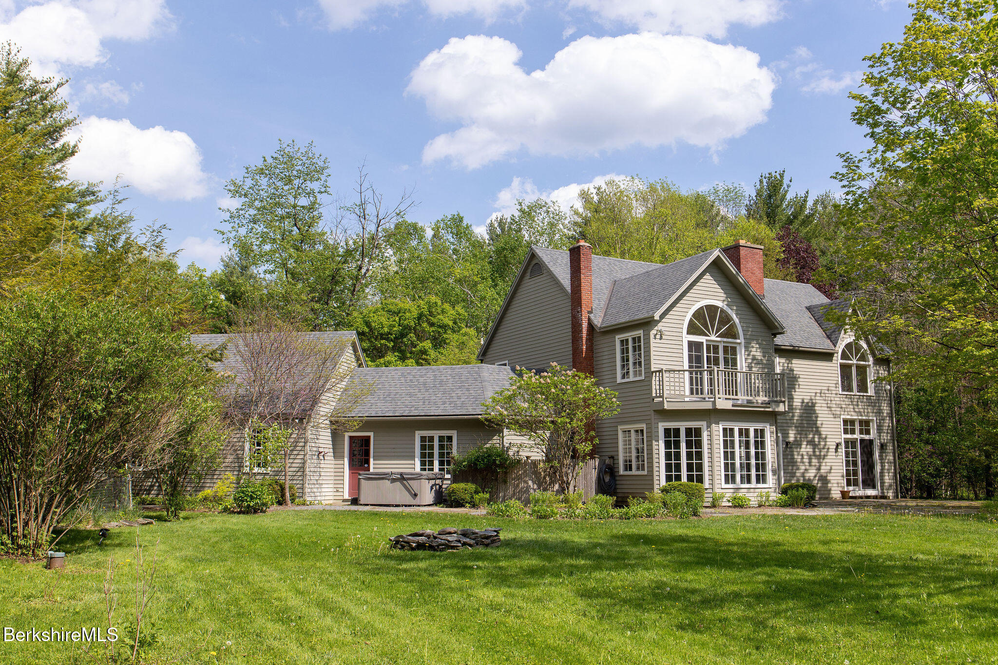 14 Old Tree Farm Road Stockbridge, MA 01266 - Photo 3 of 50 a front view of a house with a garden and trees