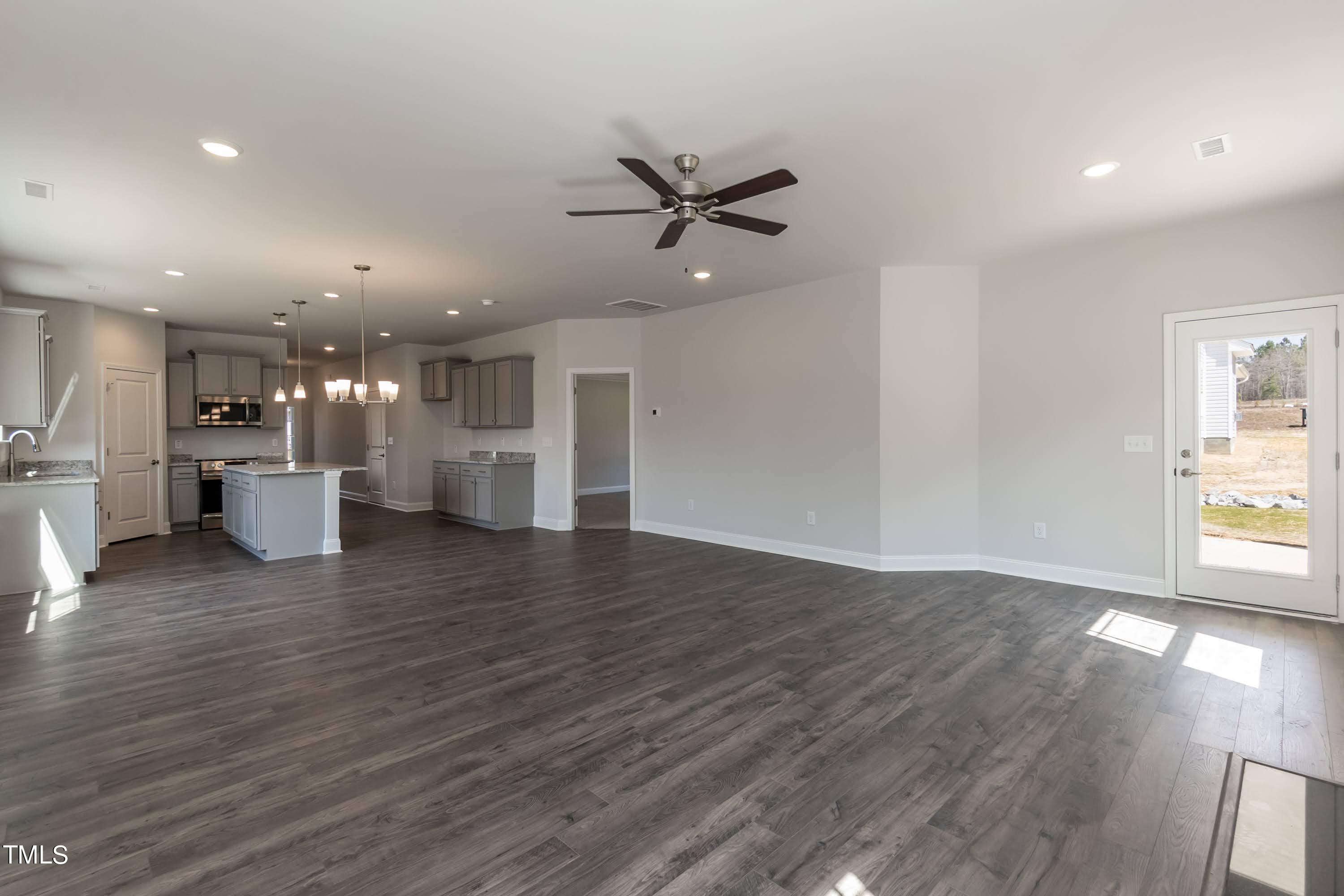 45 High Hampton Way Fuquay-Varina, NC 27526 - Photo 14 of 43 a view of an empty room and kitchen with wooden floor