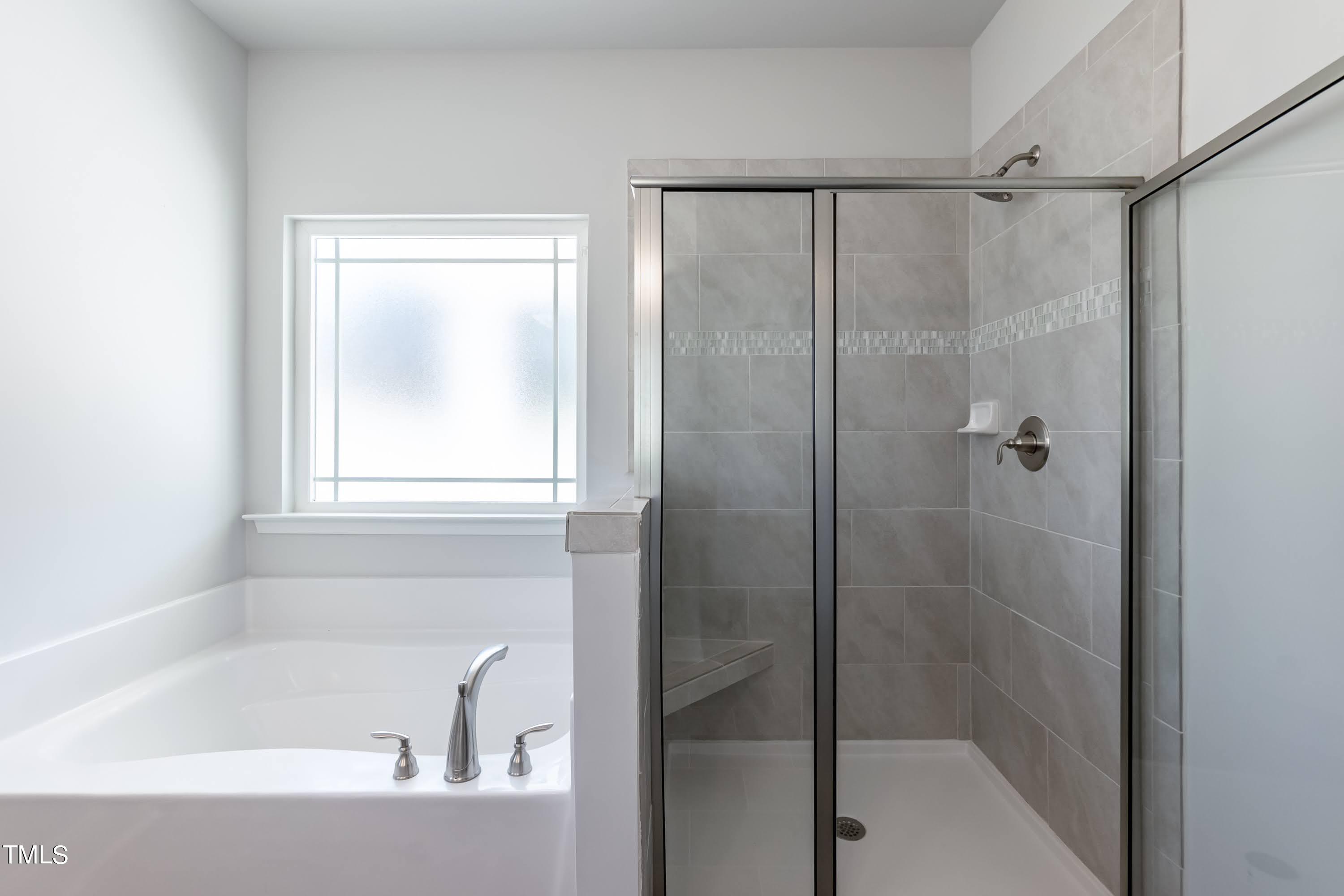 45 High Hampton Way Fuquay-Varina, NC 27526 - Photo 18 of 43 a bathroom with a bathtub and a shower