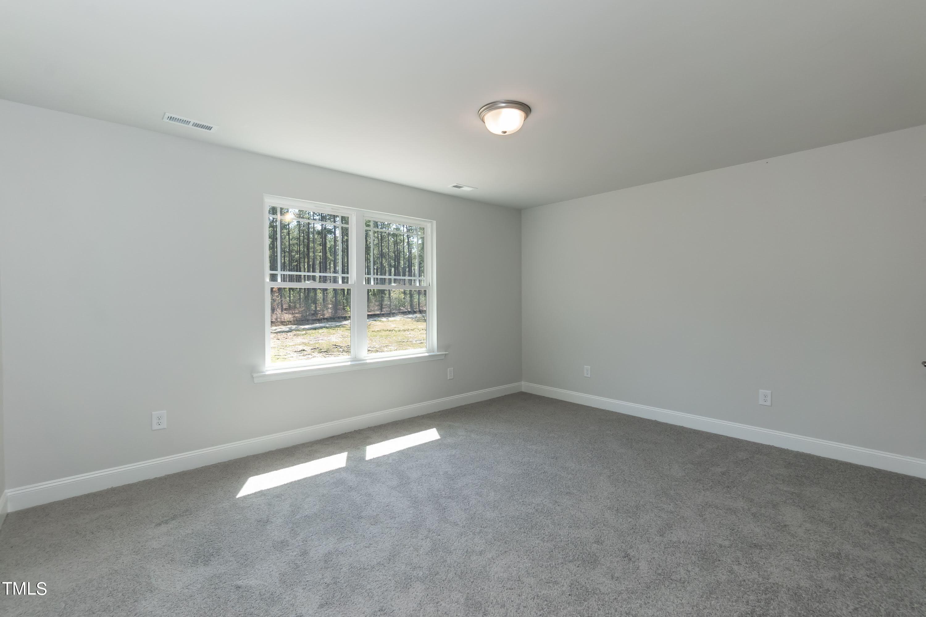 45 High Hampton Way Fuquay-Varina, NC 27526 - Photo 20 of 43 an empty room with a window