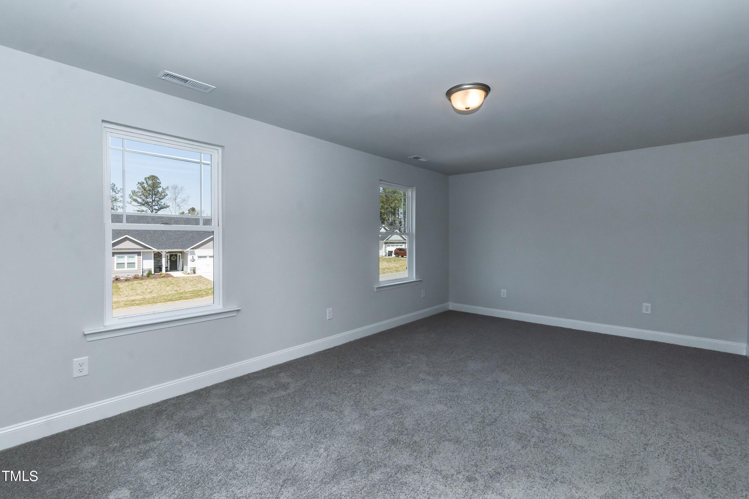 45 High Hampton Way Fuquay-Varina, NC 27526 - Photo 24 of 43 an empty room with windows