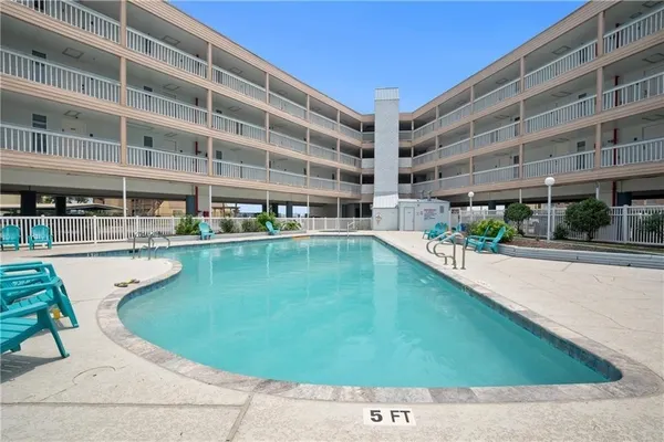 a view of swimming pool with outdoor seating