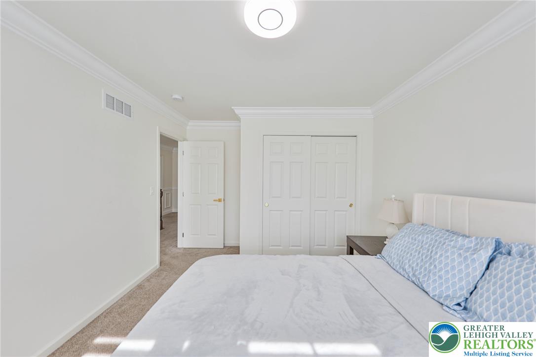 1105 Meco Road Easton, PA 18040 - Photo 82 of 100 Crisp crown molding accents the clean lines of this quiet, carpeted bedroom retreat.