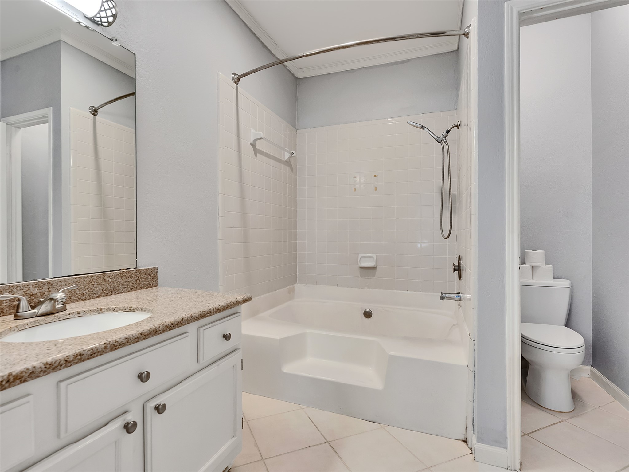 4001 Tanglewilde Street, Unit 605 Houston, TX 77063 - Photo 23 of 29 a bathroom with a granite countertop sink a toilet and shower