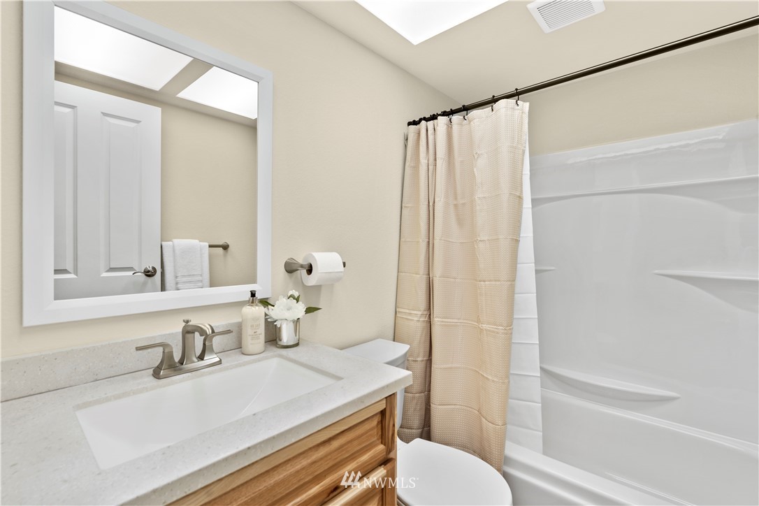 604 216th Street Southwest Bothell, WA 98021 - Photo 11 of 33 a bathroom with a granite countertop sink toilet and shower