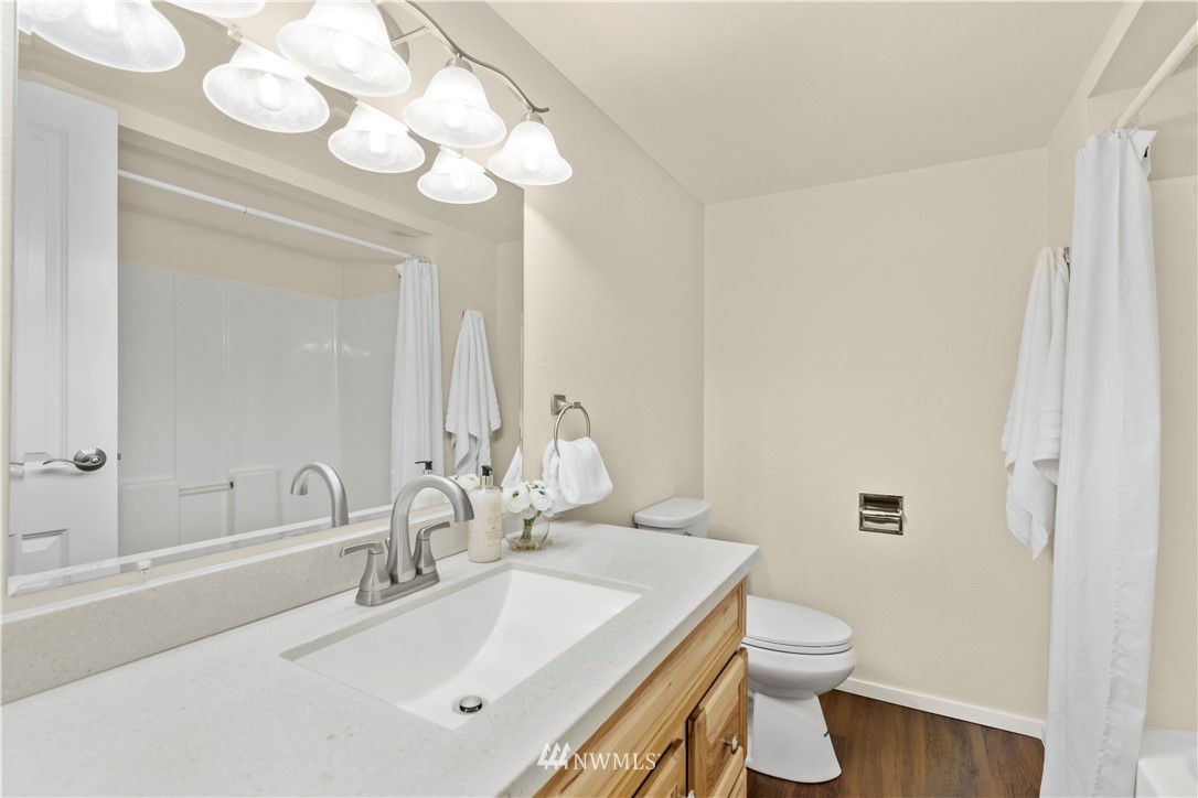604 216th Street Southwest Bothell, WA 98021 - Photo 14 of 33 a bathroom with a sink a toilet and a mirror