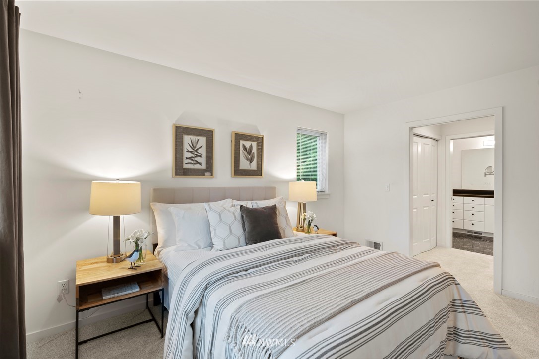 604 216th Street Southwest Bothell, WA 98021 - Photo 25 of 33 a bedroom with a bed and a lamp
