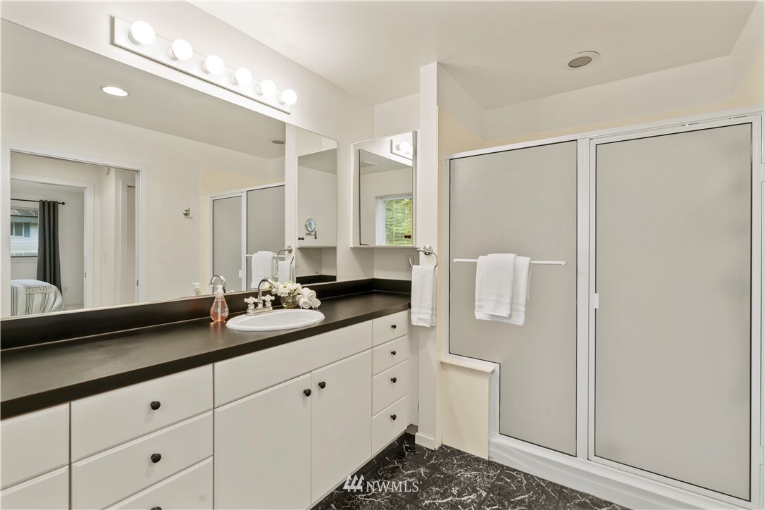 604 216th Street Southwest Bothell, WA 98021 - Photo 27 of 33 a spacious bathroom with a double vanity sink a mirror and shower