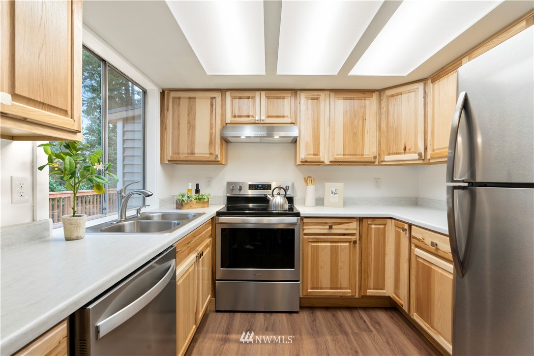 604 216th Street Southwest Bothell, WA 98021 - Photo 6 of 33 a kitchen with a sink stove and cabinets