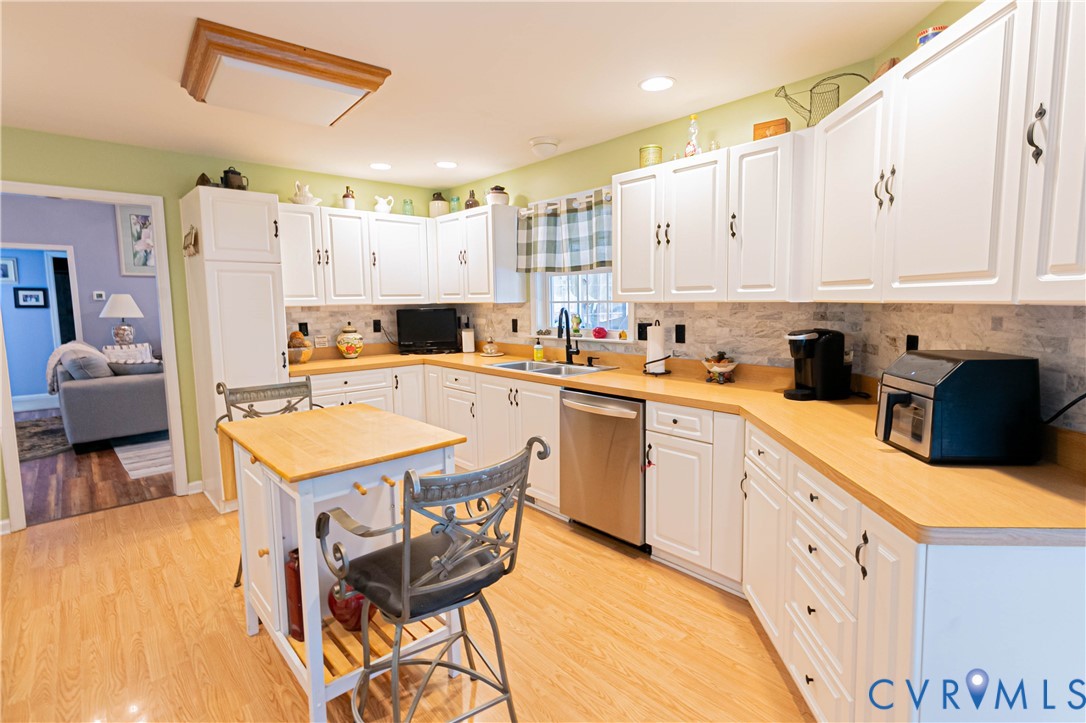 401 Loyalist Drive Ruther Glen, VA 22546 - Photo 14 of 45 a kitchen that has a lot of cabinets in it and wooden floors