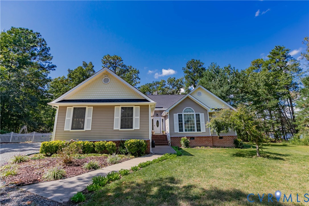 401 Loyalist Drive Ruther Glen, VA 22546 - Photo 2 of 45 a front view of a house with a garden