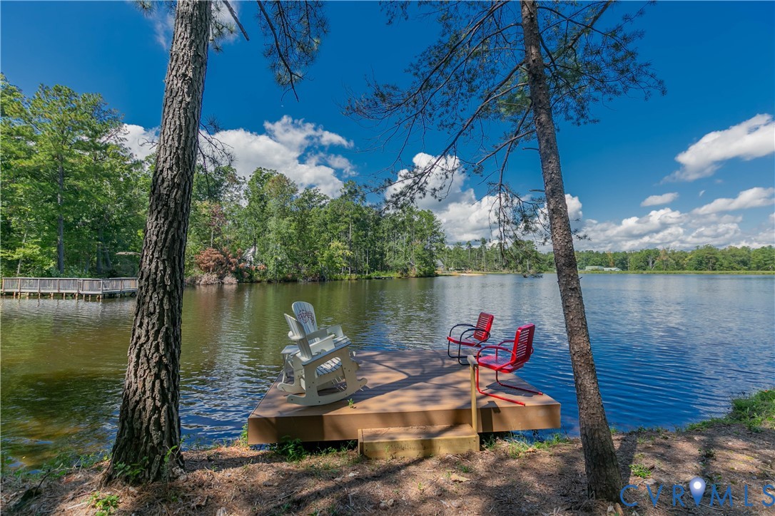 401 Loyalist Drive Ruther Glen, VA 22546 - Photo 2 of 44 a lake view with a table and chairs