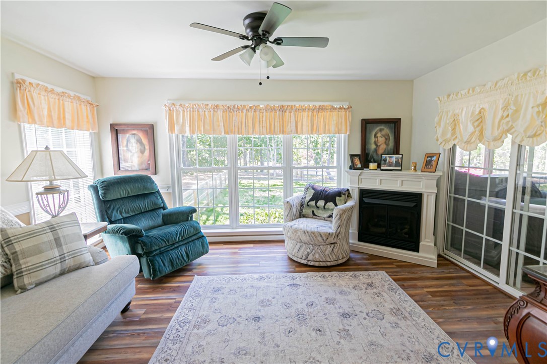 401 Loyalist Drive Ruther Glen, VA 22546 - Photo 22 of 44 a living room with furniture a large window and a fireplace