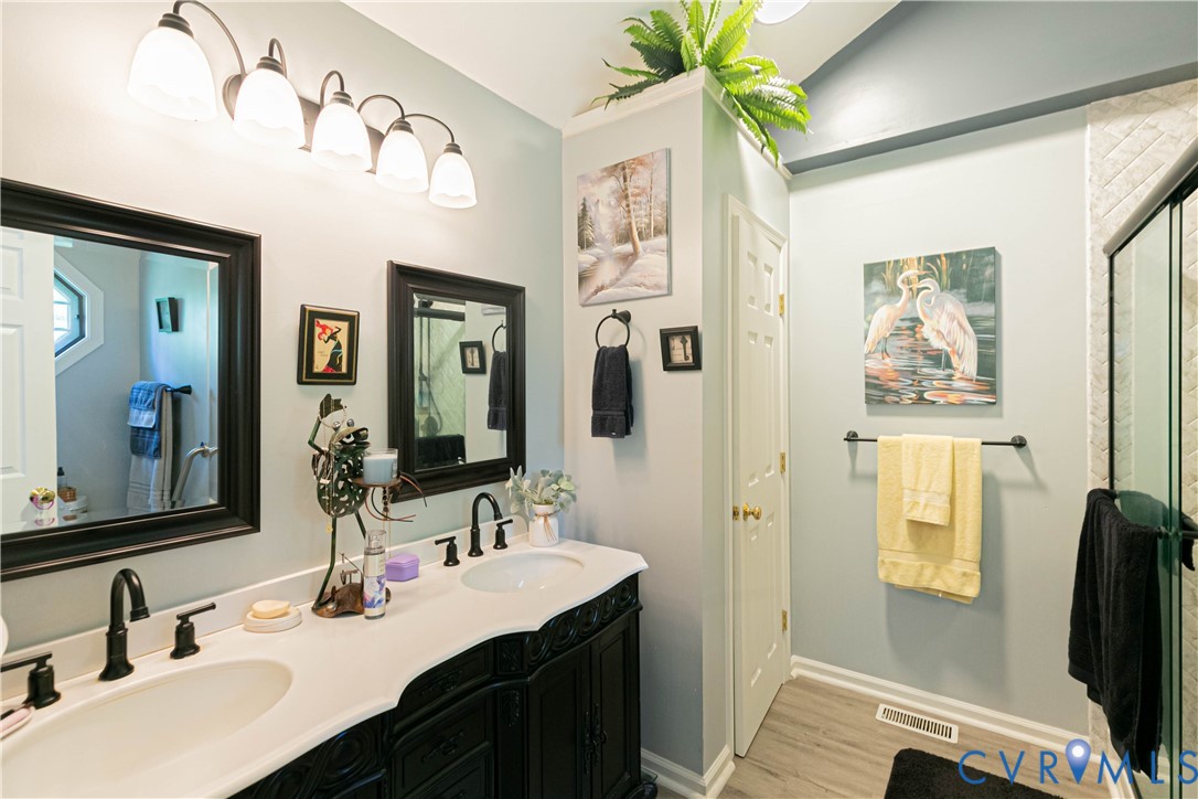 401 Loyalist Drive Ruther Glen, VA 22546 - Photo 29 of 45 a bathroom with a sink double vanity and a mirror