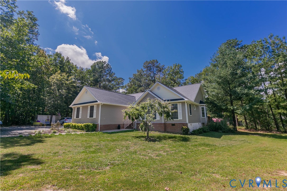 401 Loyalist Drive Ruther Glen, VA 22546 - Photo 3 of 44 a front view of a house with garden