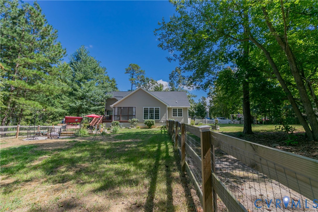 401 Loyalist Drive Ruther Glen, VA 22546 - Photo 40 of 45 a front view of a house with yard and green space