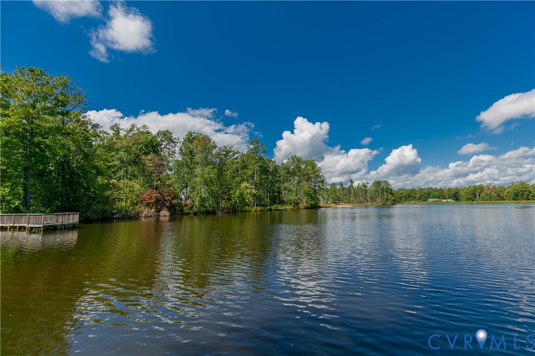 401 Loyalist Drive Ruther Glen, VA 22546 - Photo 41 of 45 a view of a lake with houses in the background