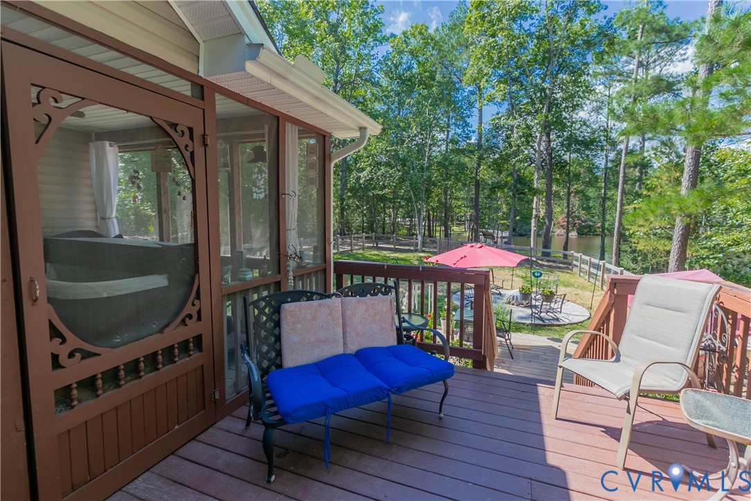 401 Loyalist Drive Ruther Glen, VA 22546 - Photo 9 of 45 a balcony with furniture and wooden floor