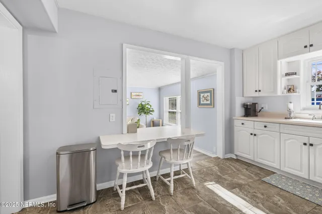 a kitchen with white cabinets and white appliances