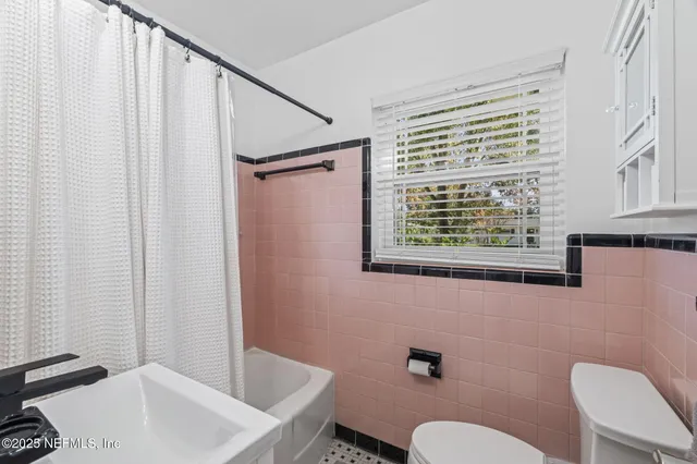 a bed room with a bed and a window