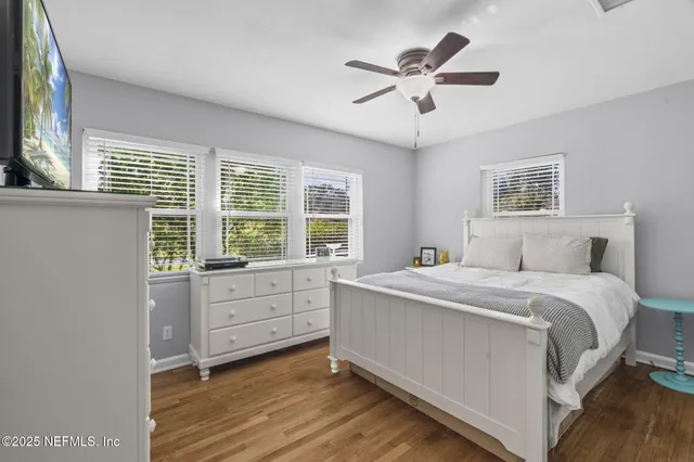 a room with a bed and a ceiling fan