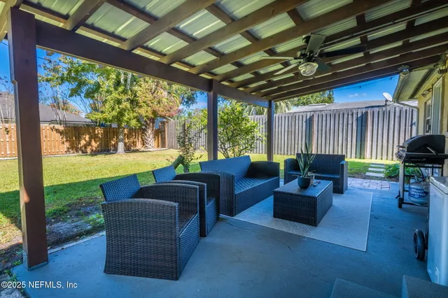a outdoor living space with patio furniture and garden view