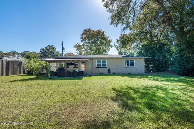 a view of a house with pool and sitting area