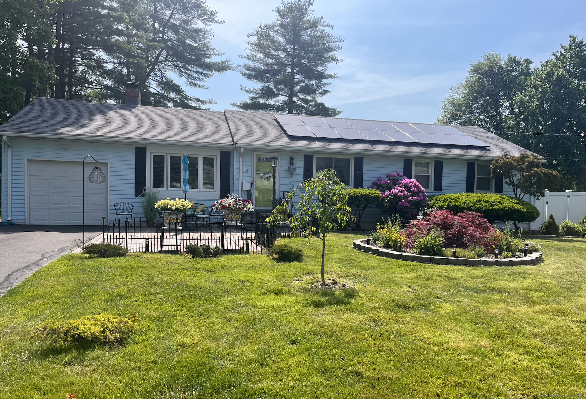 a view of a house with swimming pool and furniture