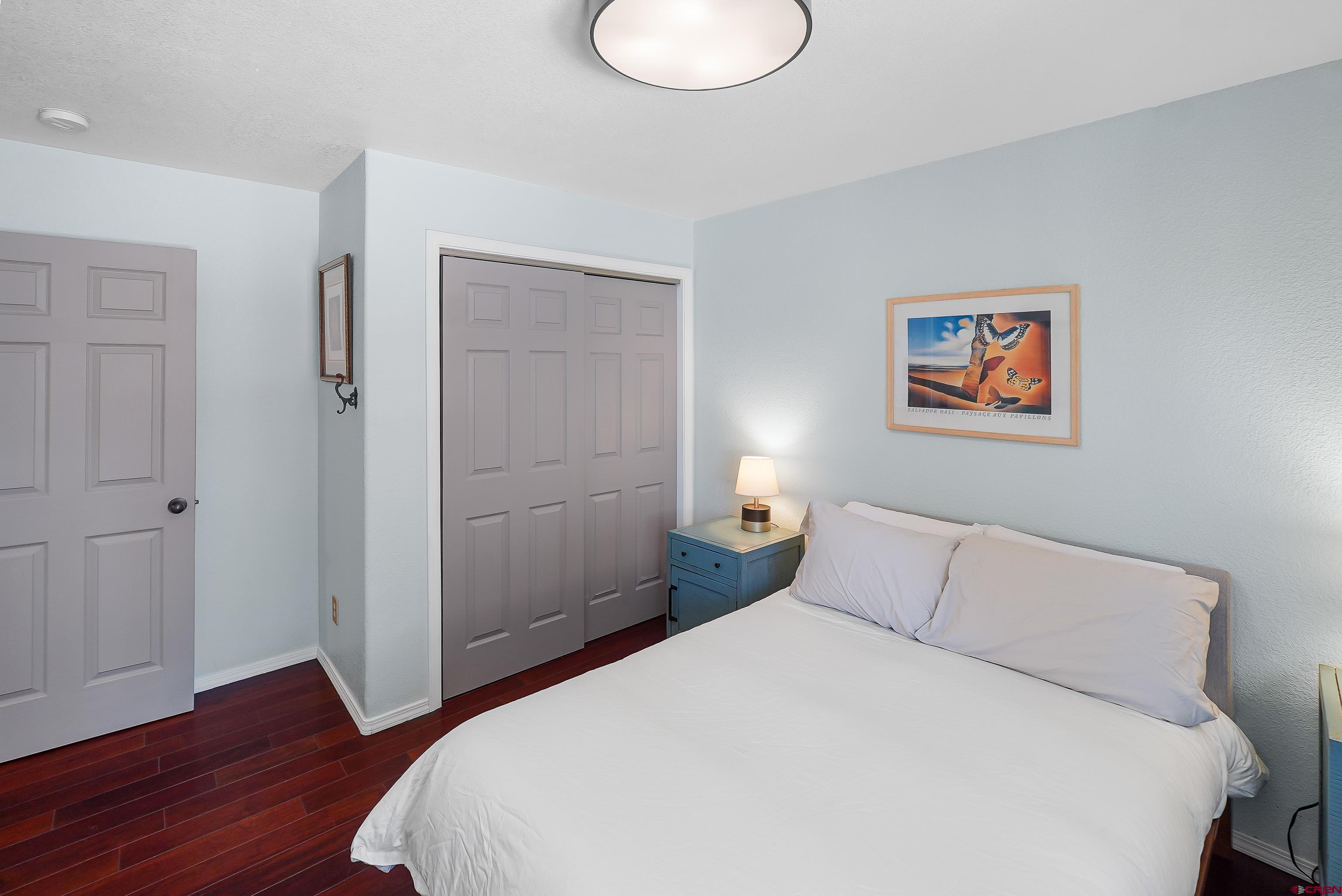100 Westridge Road Durango, CO 81303 - Photo 22 of 39 a bedroom with a bed and wooden floor